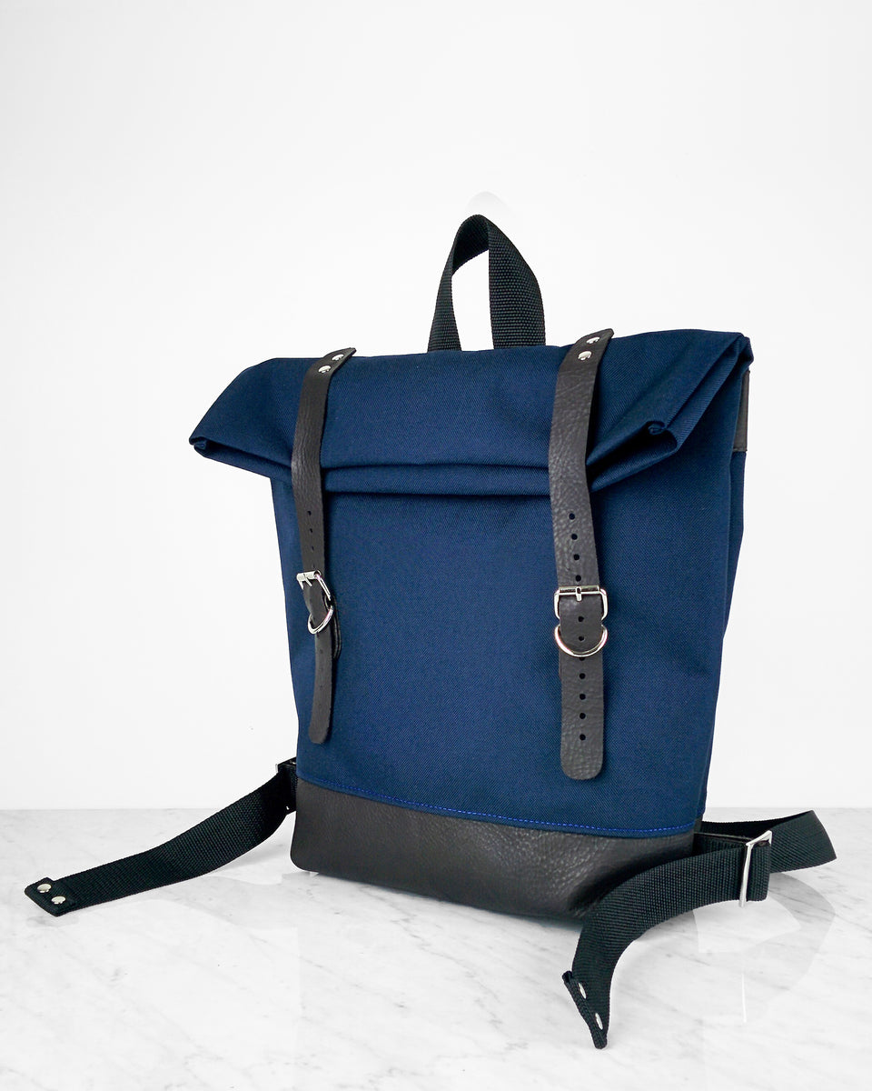 Small waxed canvas backpack in navy blue with rolled top and leather  shoulder straps